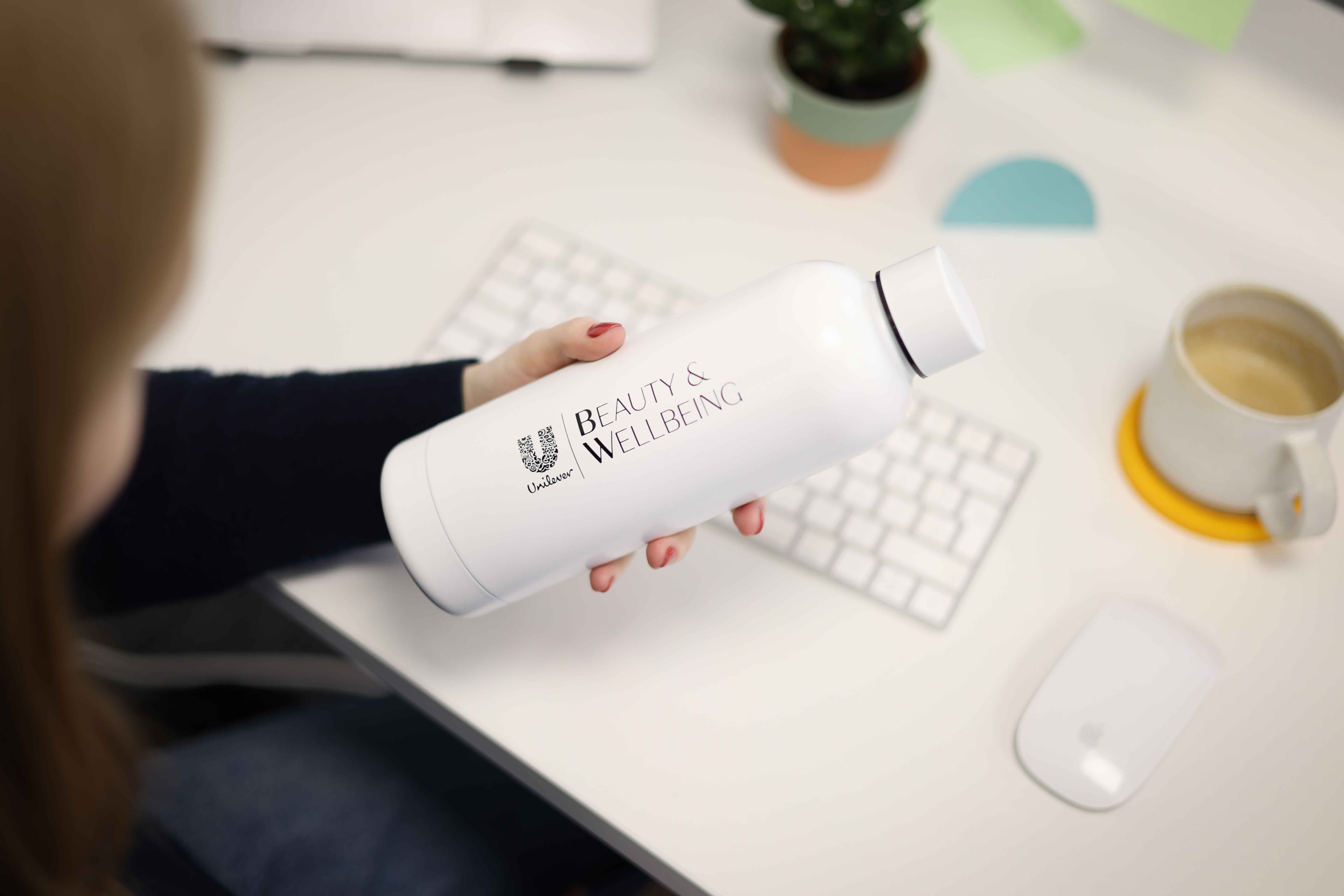 Overhead shot of a woman holding a branded insulated flask